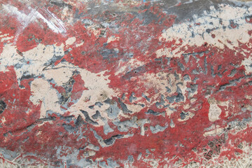 weathered, peeled and scraped red concrete wall. Background. 