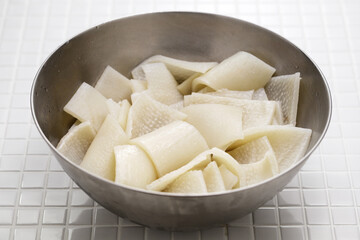 Pork rinds in a bowl. Ingredients for Cueritos (Mexican vinegared pickled pork rinds).