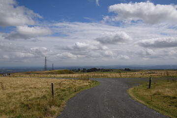 Fototapeta na wymiar a view of the radar station at Titterstone Clee summit with the sky clear blue with fluffy clouds