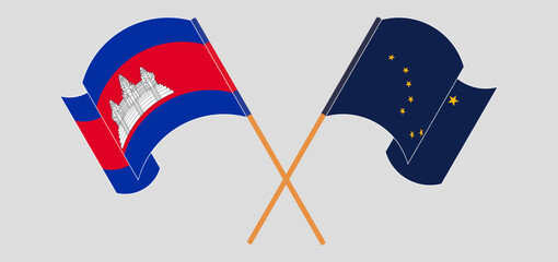 Crossed and waving flags of Cambodia and the State of Alaska