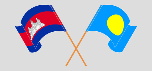 Crossed and waving flags of Cambodia and Palau