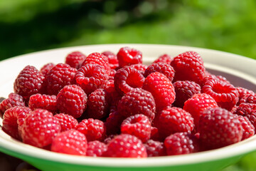 Raspberry berries. Raspberries in a bowl. Selective focus. Small depth of field. Blurred background