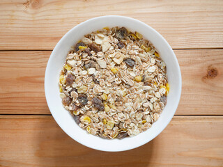 A Bowl of muesli breakfast and rolled oats  with dried fruits