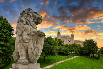 Royal castle in Lublin with guarding lion scrupture at sunset, Poland