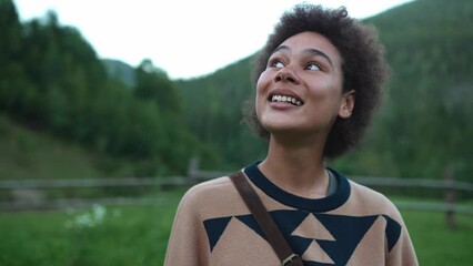 Pretty African handsome woman looking at the camera in the mountains