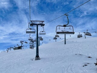 Many ski lifts crossing ski slopes in the Austrian Alps. Montafon, Vorarlberg, Austria.