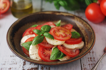 A bowl with traditional Italian caprese salad	
