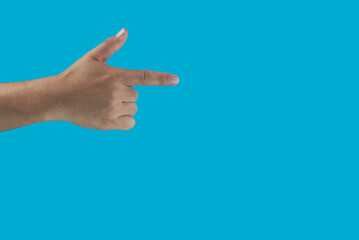 Man pointing at something on isolated blue background. closeup of handmen's fingers.