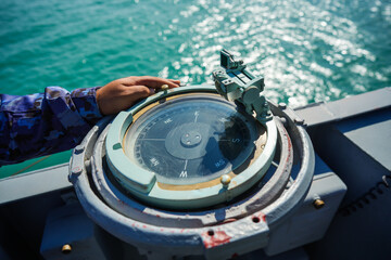 Compass on a military ship sailing on the sea