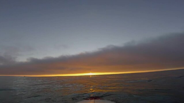 Surfer showing an amazing sunset with go pro. Great session with golden hour. silhouette view of ocean. Afife, Viana do Castelo. North of Portugal.