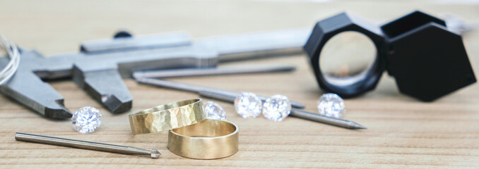 Wedding golden rings and professional jeweler equipments. Luxury diamonds. Banner
