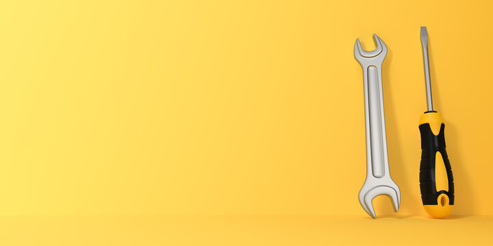 Wrench and Screwdriver on a yellow background with copy space. 3d rendering illustration