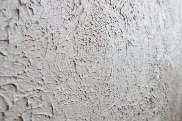 The grainy texture of wall plaster.