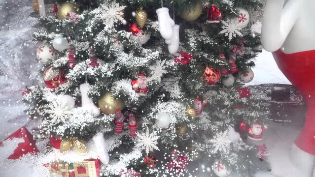 Christmas presents and tree on snow background. Slow