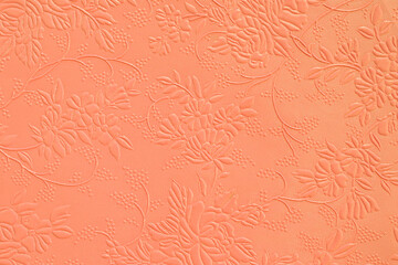 Tooled floral pattern in orange leather.