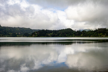 Naklejka na ściany i meble clouds reflection in the mountain lake