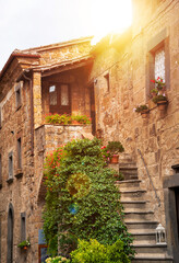 Picturesque building in medieval town in Tuscany, Italy. Old stone walls and plants