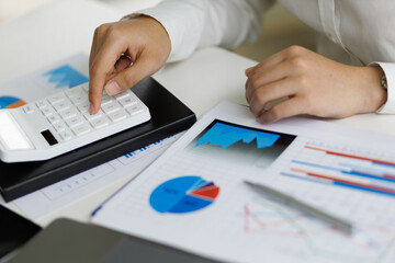 Businesswoman accountant or financial expert analyze business report graph and finance budget chart in the office. Concept of finance economy, banking business and stock market research.