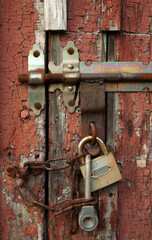 Old door with padlock and latch.