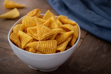Crunchy corn snack in white bowl