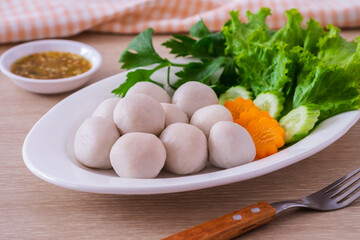 Boiled fish balls and vegetable on white plate