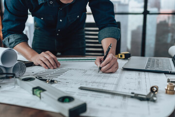 Engineering working with drawings inspection and writing on the office desk and Calculator,...