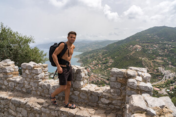 Young tourist traveler discovering and exploring the ruins of a stone castle.