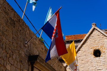 stone house facade with a hanging Croatia flag in Sibenik, Croatia