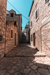 Fototapeta na wymiar narrow street in old town in Primosten, Croatia