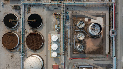 Aerial top view wastewater treatment plant from oil refinery industry zone, Purification tanks of...