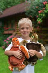 Cheerful boy with soft toys