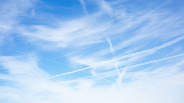 Air pollution from airplanes background / conspiracy  - Chemtrails over the blue cloudy sky