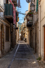 Fototapeta na wymiar Cefalu, Sicily - Italy - July 7, 2020: Small typical street in Cefalu in Sicily, Italy