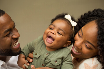 Happy young black family laughing and having fun.