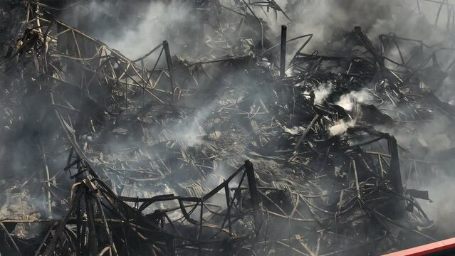 Smoking ruins of burnt down industrial storehouse