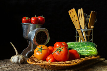 Red tomatoes and green cucumbers on a wooden table