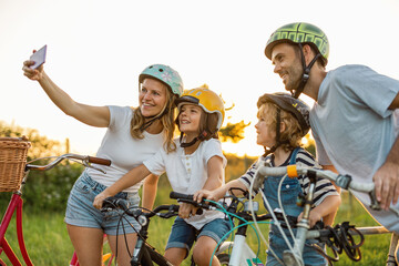 Family taking a selfie while on a bike ride
