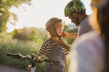 Shot of a father adjusting his son's helmet
