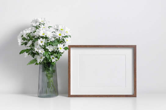 Wooden artwork frame mockup with white flowers bouquet