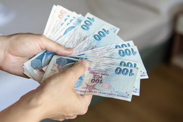 Man holds a pack of Turkish lira. Cash withdrawal in Turkey - obrazy, fototapety, plakaty