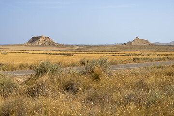 Wide arid golden desert, off road, with extreme heat and very textured, in Bardenas Reales, Navarra, Spain