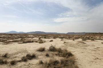 Fototapeta na wymiar Wide arid desert, off road, with extreme heat and very textured, in Bardenas Reales, Navarra, Spain