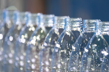 Close up scene of the empty drinking water bottles  on the conveyor belt for filling process.
