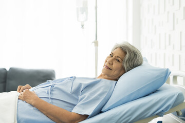 Elderly asian woman laying on bed at hospital ward. medicine, health care, old people and...