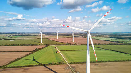 Drone aerial view of wind farm with wind turbines generating electricity. Image with copy space.