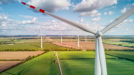Drone aerial view of wind turbine generating electricity. Wind farm visible in the background....