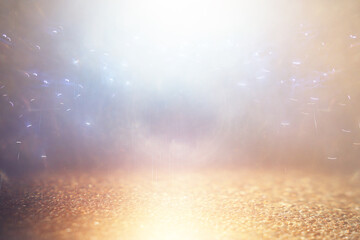 background of abstract gold, blue and silver glitter lights. defocused