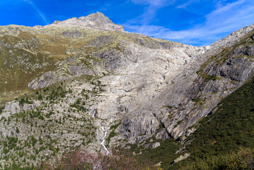 View of famous Rhone Glacier in the Swiss Alps with glacier river on a sunny late summer day. Photo taken September 12th, 2022, Furka Pass, Switzerland.