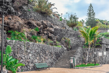 Stone terraces with stairs on the promenade in Puerto de la Cruz in Tenerife, Spain. Exotic garden...