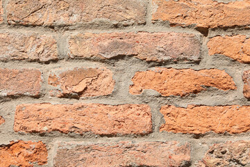 detail of the wall of  red bricks and lime and mortar